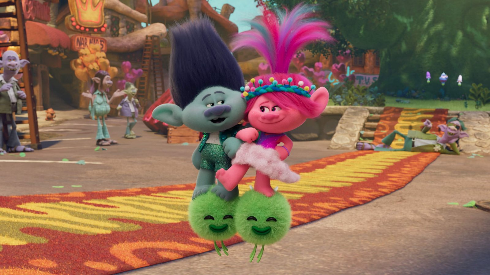 Trolls Band Together - Branch and Poppy on a colorful village path. Scene still © DreamWorks Animation / Universal Pictures