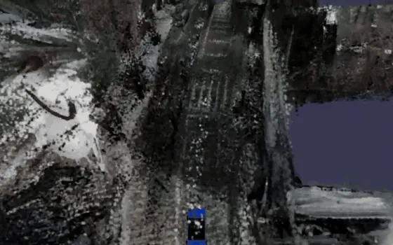 Real-time 3D Gaussian-splat city reconstruction in the Iris digital-twin viewer, driving through a reconstructed street